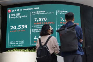 A screen displaying the Hang Seng stock index is seen at Central district
